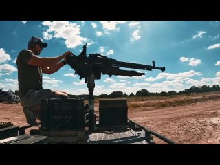 an american shoots from a soviet machine gun dshk
